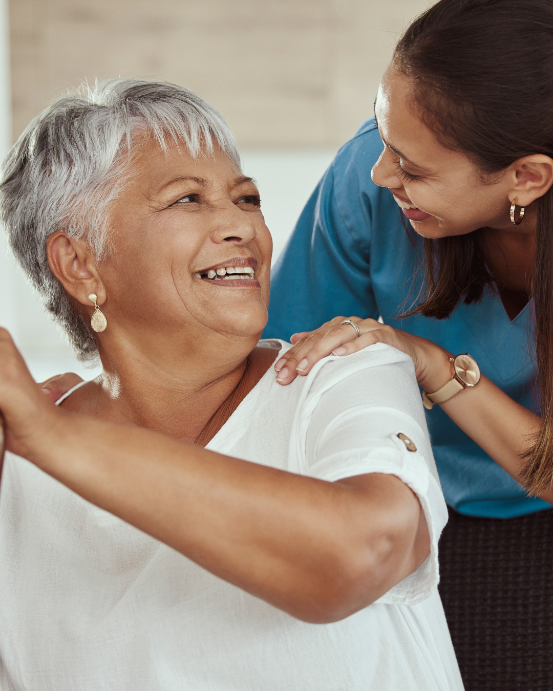 Elderly man smiling with caregiver