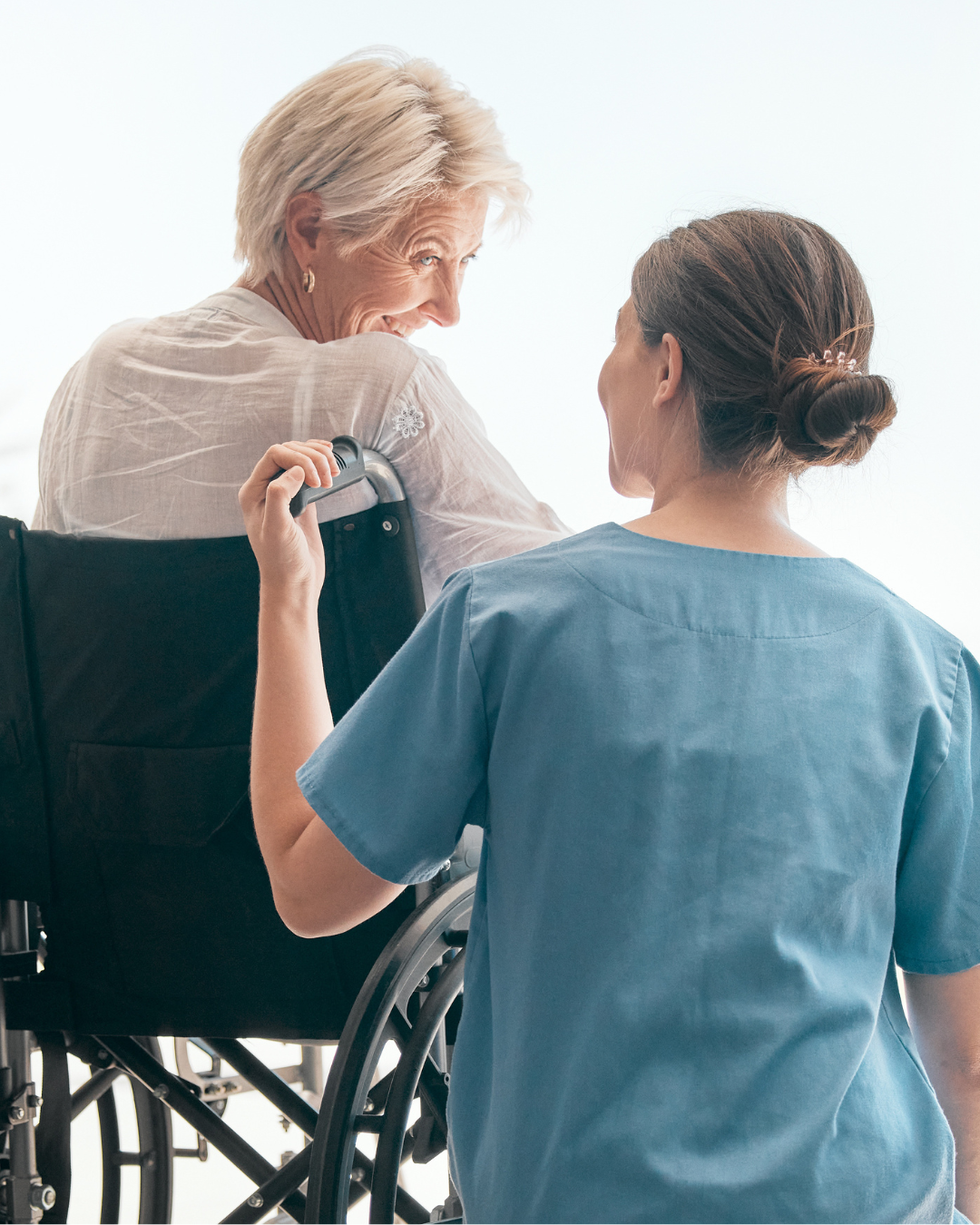 Elderly man smiling with caregiver